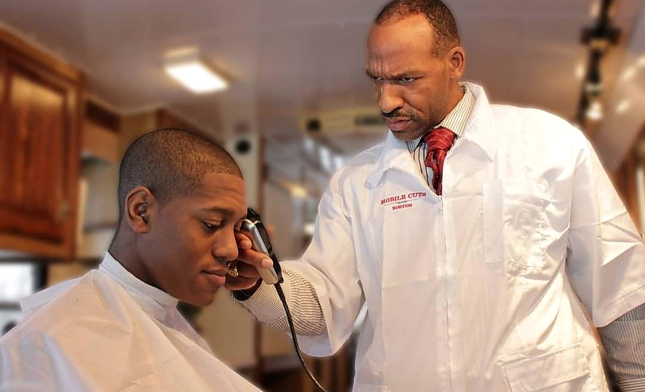Christopher Roberts at work, cutting a client's hair with precision